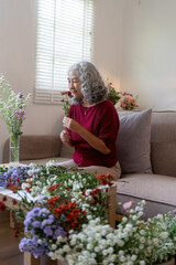 Elderly Woman Arranging Fresh Flowers at Home