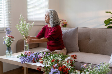 Elderly Woman Arranging Fresh Flowers at Home