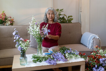 Senior Woman Taking Photo of Her Floral Arrangement