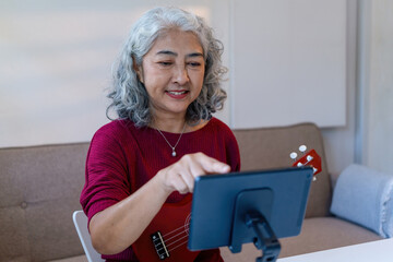 Senior Woman Using Tablet For learning Instrument
