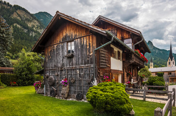 A traditional wooden cottage in the village of Almens in Switzerland in summer
