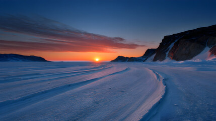 Majestic sunrise over snow-covered mountains highlighting the beauty of winter wilderness at dawn