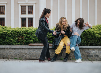 Three young women enjoying a fun and playful moment while sitting on a bench outdoors.