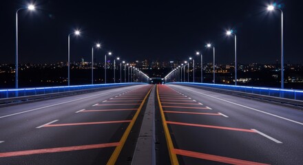 Modern highway bridge illuminated by streetlights at night, providing a symmetrical view of the road ahead towards the city.