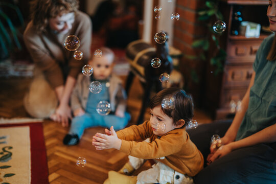 A joyful scene of adults and children playing with bubbles in a cozy living room, creating memories and sharing happiness in a playful family moment.
