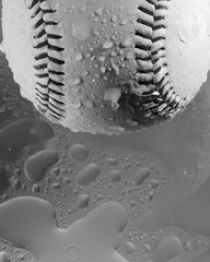 Baseball in water, wet for rain game concept.