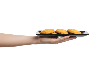 Hand holding plate with golden cookies on a white background