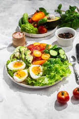 Healthy Salad Bowl with Avocado, Eggs, Tomatoes and Cucumbers, 
