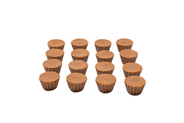 Fudge Cups in Rows White Background. Three rows of round fudge cups arranged in a grid pattern. The candies are displayed on a white background with clear spacing.