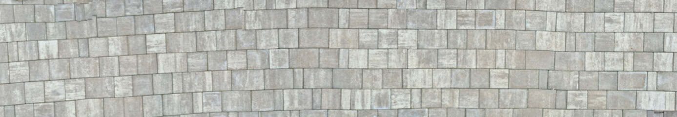 A close-up view of a textured stone wall, featuring varied shades of gray and unique patterns, suitable for background, design, and architectural projects.