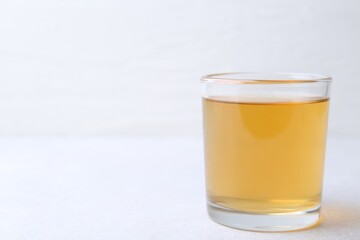 Glass with dirty water on light table, closeup. Space for text