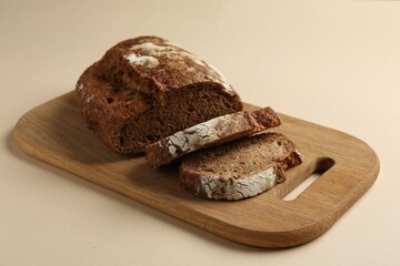 Pieces of fresh rye bread on beige background, closeup