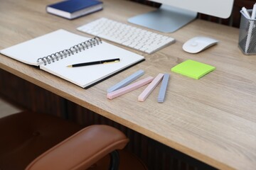 Different stationery on wooden desk indoors, closeup
