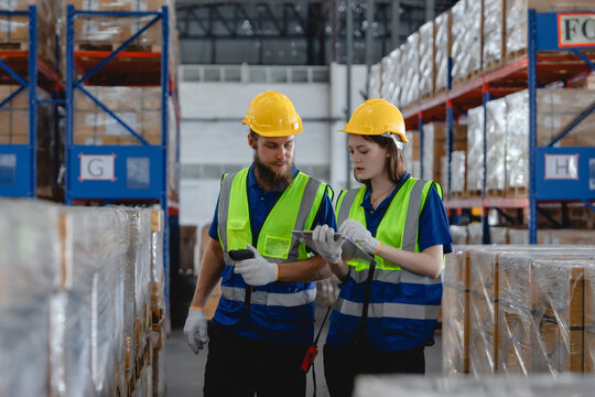 Industrial workers checking inventory in auto parts warehouse using digital devices, emphasizing logistics and supply management, Warehouse scanning and tracking system
 - Powered by Adobe