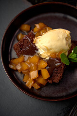 Decadent Chocolate Cake Topped with Fresh Fruit Compote and Creamy Ice Cream: A Delightful Dessert Experience