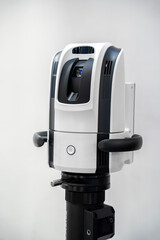 Industrial scanner laser tracker radian measures key features from a distance isolated on white background.