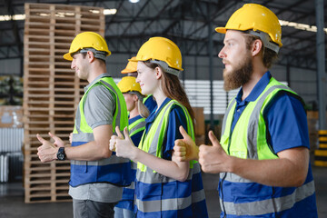 Group of confident male warehouse workers standing in a row giving thumbs up in large logistics center, Workplace positivity, Team success concept.