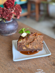 Slice of banana cake on the wooden table.