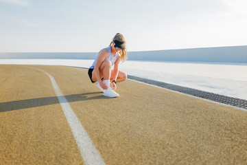Runner checking her gear on a track during an inspiring training session