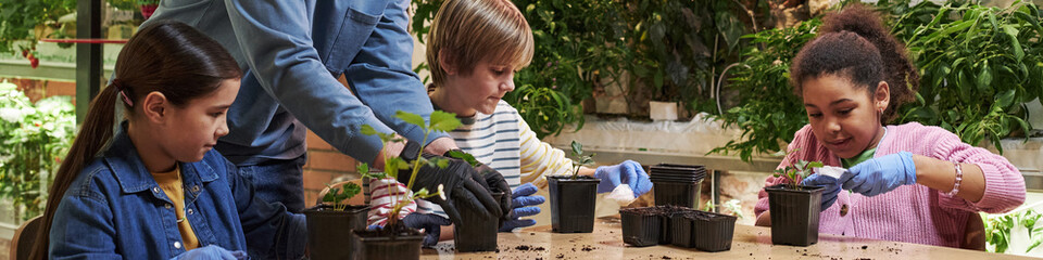 Header of diverse group of children gardening together, planting seedlings in pots at table,...