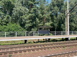 Wooden bench on suburban railway platform