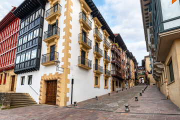 Fototapeta premium Streets with houses of beautiful architecture in the north of Spain, picturesque villages of the Basque Country, Hondarribia.