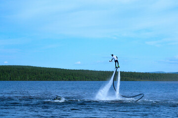 Flight on Jetpack Over Lake in Summer