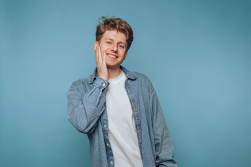 Young Man Smiling with Hand on Cheek