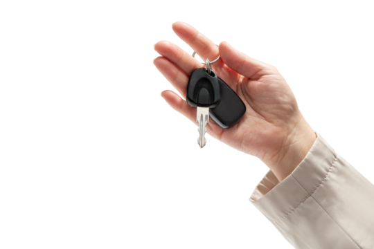 Hand holding car keys on isolated background. Concept of selling or renting a car