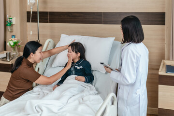Fototapeta premium Caring Asian Female Doctor with Child Patient and Mother
