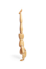 A wooden mannequin doing handstand with legs raised on white background with copy space
