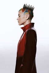 Woman with colorful mohawk hairstyle and crown, wearing a red leather jacket, standing in profile...