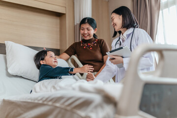 Caring Asian Female Doctor with Child Patient and Mother