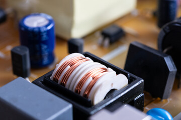 Close up of electronic components in television, electromagnetic interference filter with plastic core