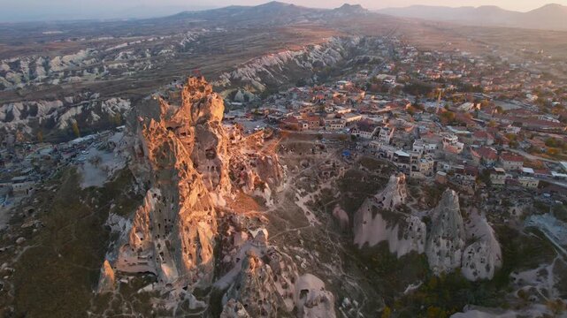 Aerial evening view Ancient Uchisar castle, underground city of Cappadocia Turkey, Goreme national park.