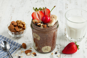 chocolate overnight oats with fresh berries,  banana and  nuts