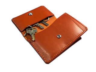Brown leather key pouch with keys isolated on transparent background
