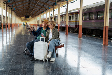 Happy Asian senior boarding a train at the station