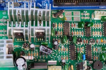 A green electronic circuit board background, close up