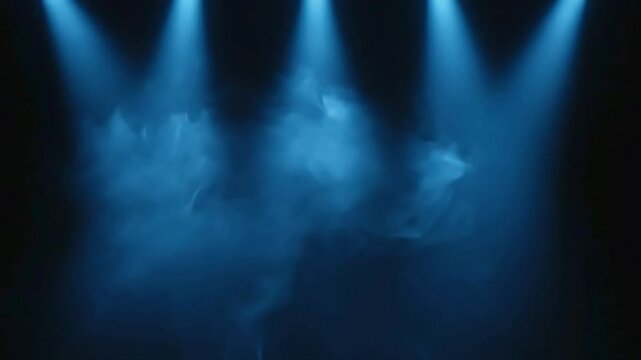 Blue spotlights piercing through thick smoke creating a dramatic and mysterious atmosphere on a dark stage an abstract background or overlay for events concerts