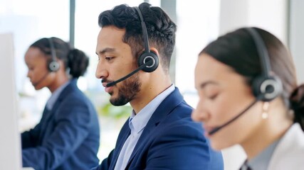 Businesspeople wearing headsets, focused on work