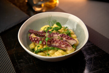 A Beautifully Arranged Dish Featuring Tender Octopus and Creamy Gnocchi with Fresh Greens, Showcasing a Perfect Balance of Flavors and Textures
