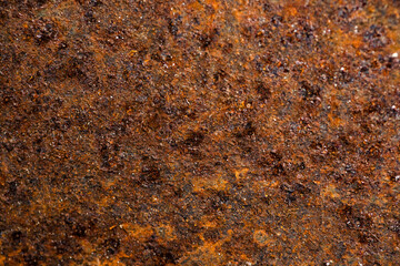 Close-up of a rusted metal surface with a crack. aged iron background.