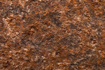 Close-up of a rusted metal surface with a crack. aged iron background.