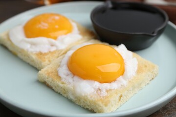 Tasty kaya toasts with half-boiled eggs served on table, closeup. Traditional asian breakfast