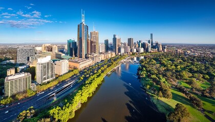 drone vertical shot of the melbourne cityscape with a river and green trees on a sunny day