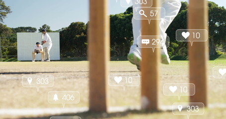 Jumping bowler delivering ball on park cricket field, with stumps and social icons