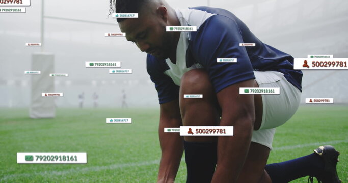 Kneeling athlete wearing cleats tying laces on misty field, with goalposts and tracking tags