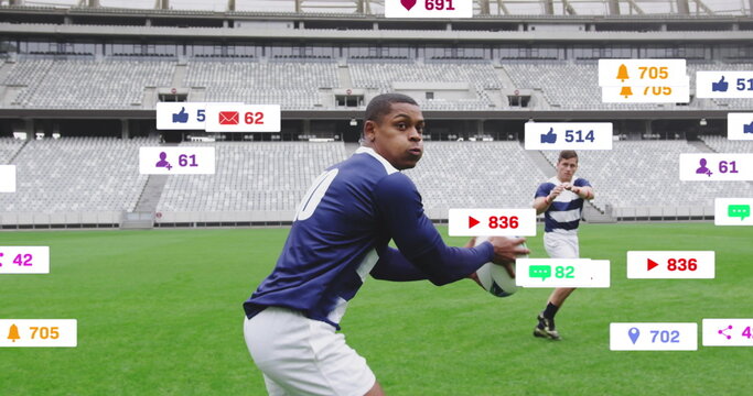Rugby player wearing blue-and-white uniform holding ball on stadium field, digital overlay icons