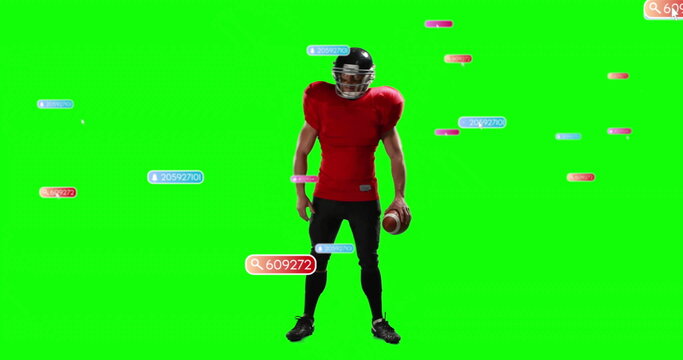 Football player in jersey, black helmet holding football in green screen studio, with data labels